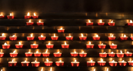Many burning devotional candles. - Selected Focus, narrow depth of field.の写真素材