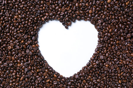 Coffee beans forming heart shaped on white background.の写真素材