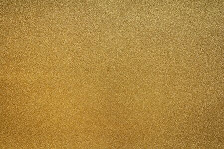 Fine Detailed texture of glittering golden dust surfaceの写真素材