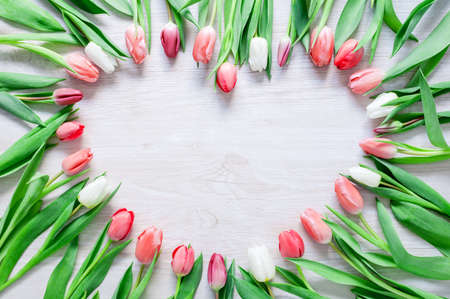 Heart from Red Tulips Flowers on rustic table for March 8, International Womens Day, Birthday , Valentines Day or Mothers day - Closeupの写真素材
