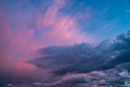 Dramatic cloudy sky at sunset. Dark color. Sky texture, abstract nature backgroundの写真素材