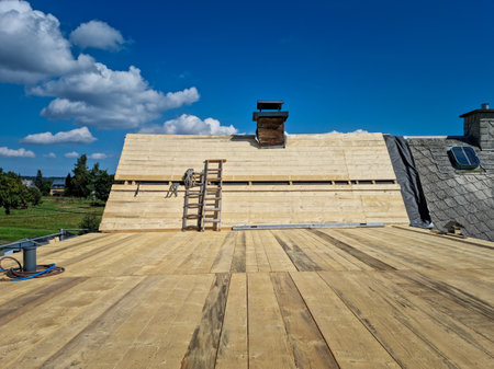 Installation of new roof boards at construction of the assembled roof on houseの写真素材