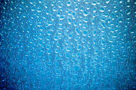 Drops water on the clear glass backgroundの写真素材