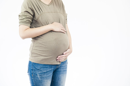 Image of pregnant woman touching her belly with handsの写真素材