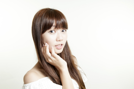 Portrait of beautiful young girl with clean skin on pretty face - white backgroundの写真素材