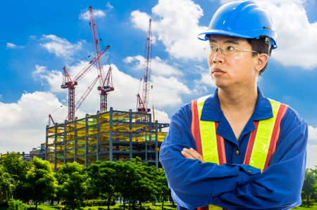 construction worker checking location site with crane on the backgroundの写真素材