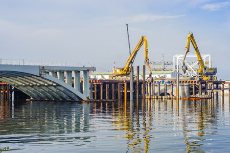 KAOHSIUNG, TAIWAN -- JUNE 14, 2016: An excavator drives a pile into the river bed as construction of a new bridge across the Love River continues.のeditorial素材