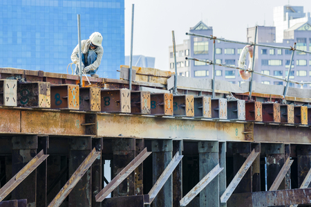 KAOHSIUNG, TAIWAN -- JUNE 14, 2016: An excavator drives a pile into the river bed as construction of a new bridge across the Love River continues.のeditorial素材