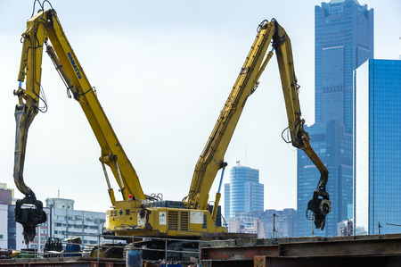 KAOHSIUNG, TAIWAN -- JUNE 14, 2016: An excavator drives a pile into the river bed as construction of a new bridge across the Love River continues.のeditorial素材