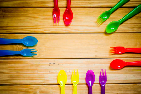 Kids funny eating. Composition of Colorful cutlery on wooden table