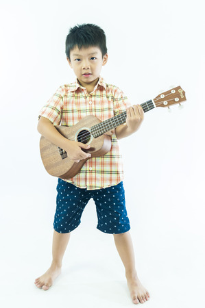 Cute little boy with ukulele guitarの写真素材