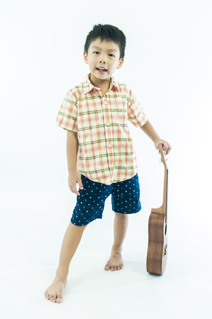 Cute little boy with ukulele guitarの写真素材