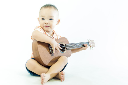 Cute little boy with ukulele guitarの写真素材