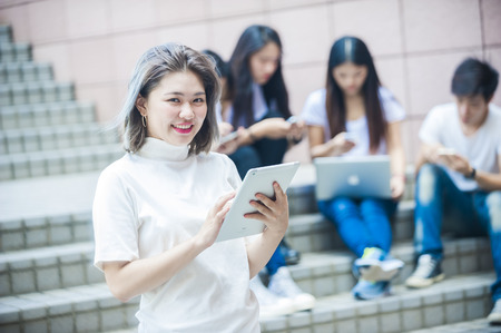 group of happy college students outdoorsの写真素材