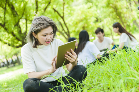 group of happy college students outdoorsの写真素材