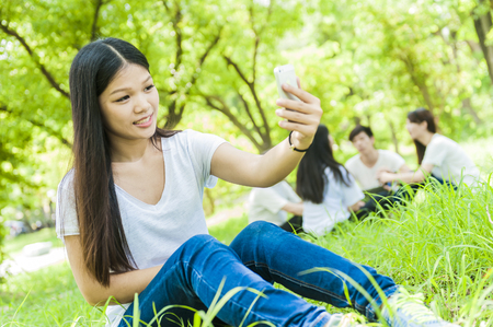 group of happy college students outdoorsの写真素材