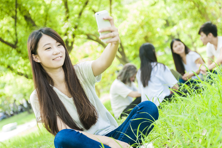 group of happy college students outdoorsの写真素材