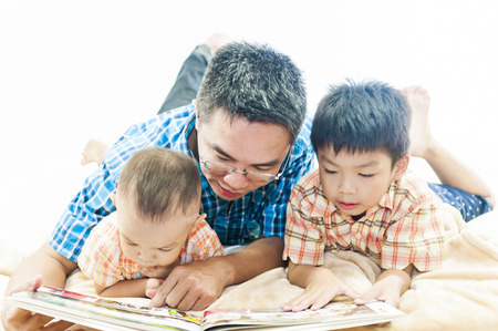 father reading book to kids, family leisureの写真素材
