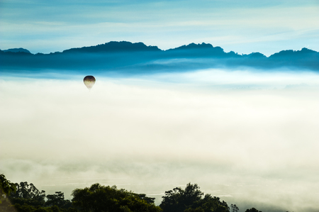 hot air balloons landing in a fieldの写真素材