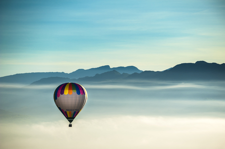 hot air balloons landing in a fieldの写真素材