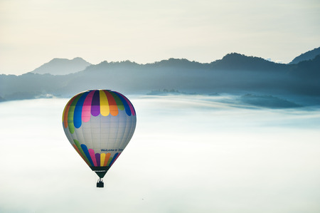 hot air balloons landing in a fieldの写真素材