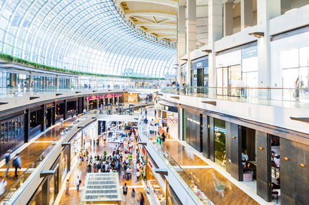 SINGAPORE - August 23: Timelapse in motion - inside view in the shopping mall "The Shoppe" at Marina Bay Sands on August 23, 2017 in Singapore.のeditorial素材