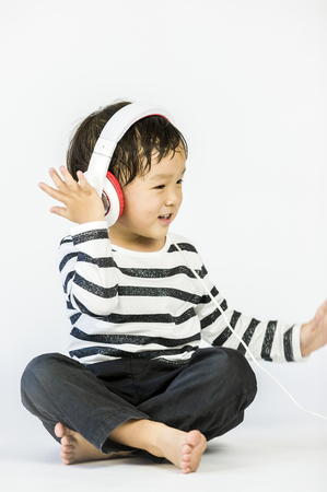 Boy listen to music on a white backgroundの写真素材