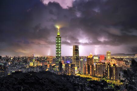 Skyline view of Taipei glowing in the sunset lightの写真素材