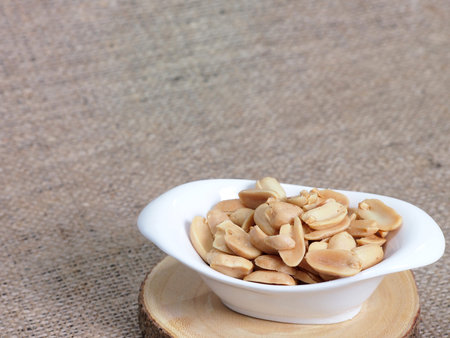 Roasted salted peanuts in white bowl