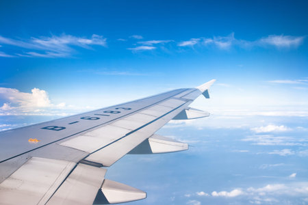 View of jet plane wing with cloud patternsのeditorial素材