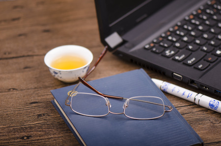 Stationery and laptop on a wooden table のeditorial素材