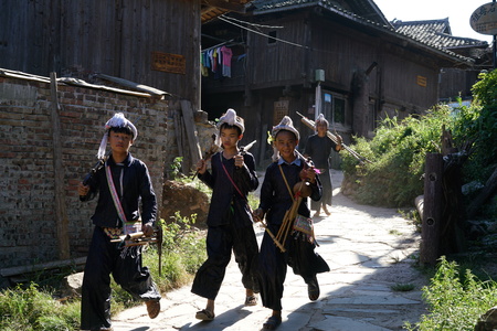 View of Miao's Villagers walking down the steep roadのeditorial素材