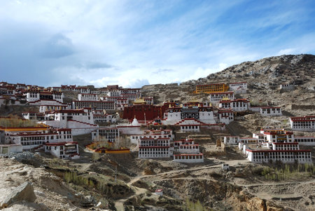  Tibetan monastery, build high on a hill with deep blue sky behind  