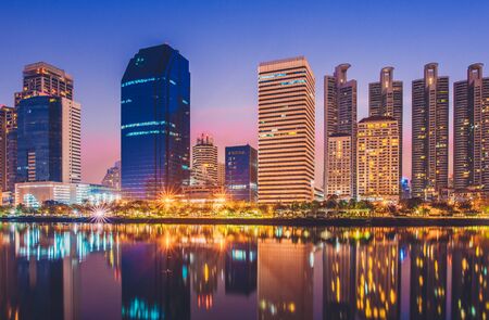 Business district cityscape from park,Benchakitti Park in Morning with cityscape reflection, Bangkok Thailand.の写真素材