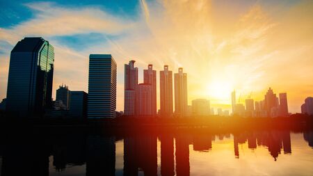Business district cityscape from park,Benchakitti Park in Morning with cityscape reflection, Bangkok Thailand.の写真素材