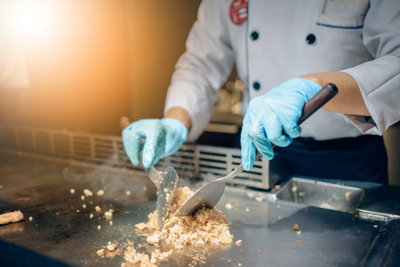 Hand of man take cooking of meat with vegetable grill, Chef cooking wagyu beef in Japanese teppanyaki restaurantの写真素材