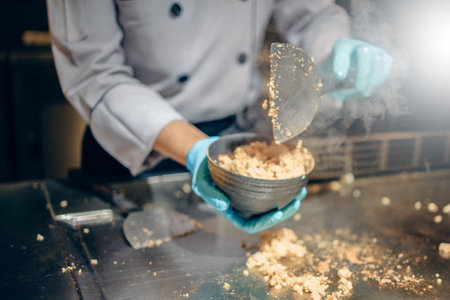 Hand of man take cooking of meat with vegetable grill, Chef cooking wagyu beef in Japanese teppanyaki restaurantの写真素材