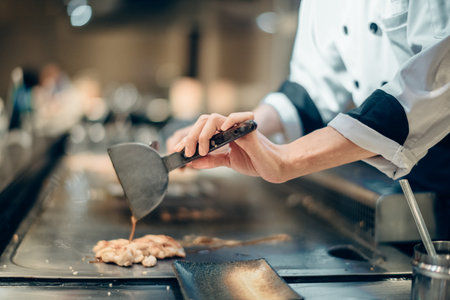 Hand of man take cooking of meat with vegetable grill, Chef cooking wagyu beef in Japanese teppanyaki restaurantの写真素材