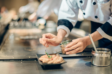 Hand of man take cooking of meat with vegetable grill, Chef cooking wagyu beef in Japanese teppanyaki restaurantの写真素材
