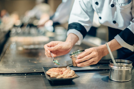 Hand of man take cooking of meat with vegetable grill, Chef cooking wagyu beef in Japanese teppanyaki restaurantの写真素材