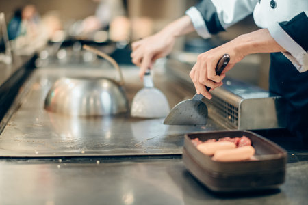 Hand of man take cooking of meat with vegetable grill, Chef cooking wagyu beef in Japanese teppanyaki restaurantの写真素材