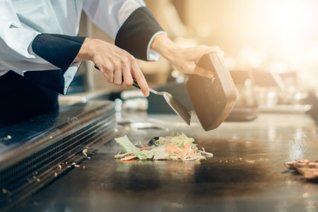 Hand of man take cooking of meat with vegetable grill, Chef cooking wagyu beef in Japanese teppanyaki restaurantの写真素材