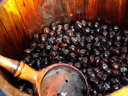 olives in a wooden pot at a street sale の写真素材