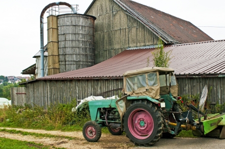 old barn with silo and tractorの写真素材