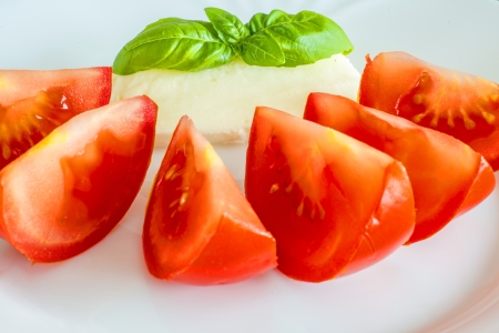 Italian appetizer tomatoes with mozarella and basilの写真素材