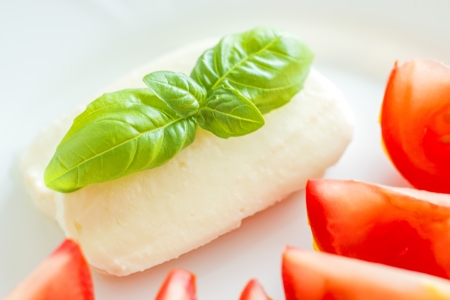 Italian appetizer tomatoes with mozarella and basilの写真素材