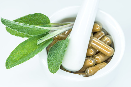 Sage leaves with herbal pillsの写真素材