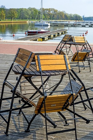 Closed street cafe in a marinaの写真素材