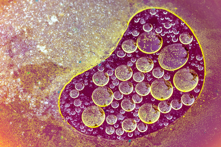 oil-drops floating  in waterの写真素材