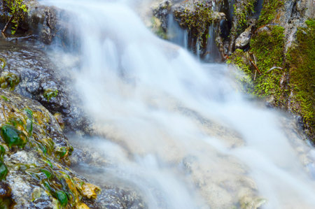 Wild creek falling down a hillの写真素材